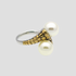 Flat lay of GRISÉ NYC two-tone pearl crossover ring.
