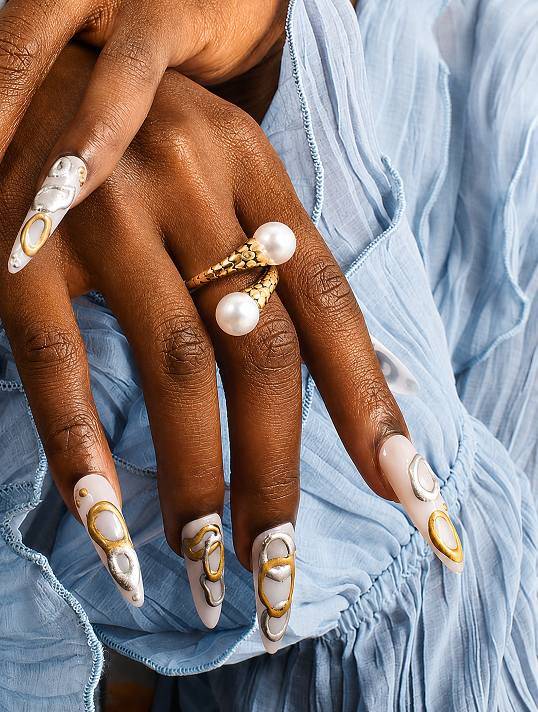 Model wearing GRISÉ NYC pearl crossover ring close up.