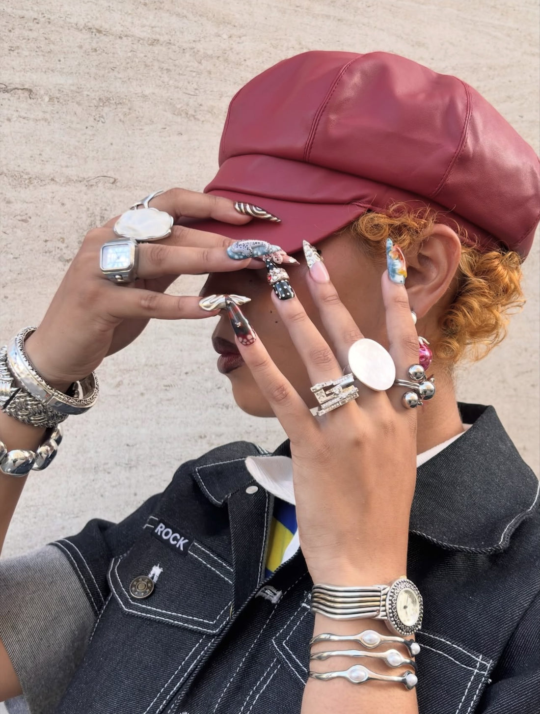 Model wearing GRISÉ NYC Wavy Perlita Steel Cuff Bracelet styled with silver statement rings.