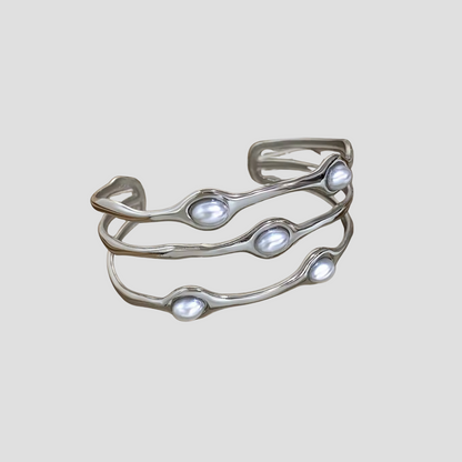 Wavy Perlita Steel Cuff Bracelet by GRISÉ NYC with modern silver wave design and pearl accents.