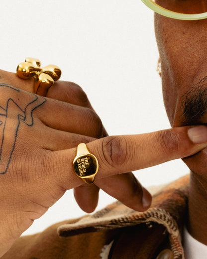 The World Is Yours signet ring styled in gold