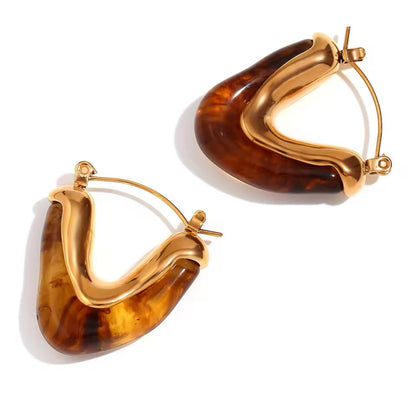 Gold V shape hoop earrings with tortoise resin detail close up