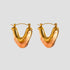 Tortoise resin V shape gold hoop earrings on gray background