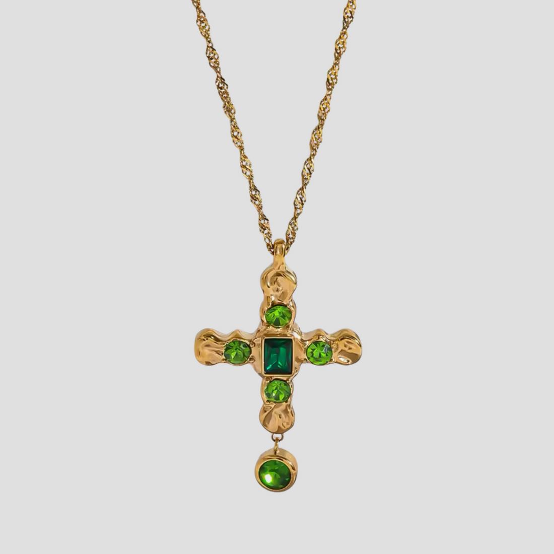 GRISÉ NYC emerald 18k gold plated cross pendant necklace in stainless steel with green gemstone detailing, unisex luxury jewelry piece.