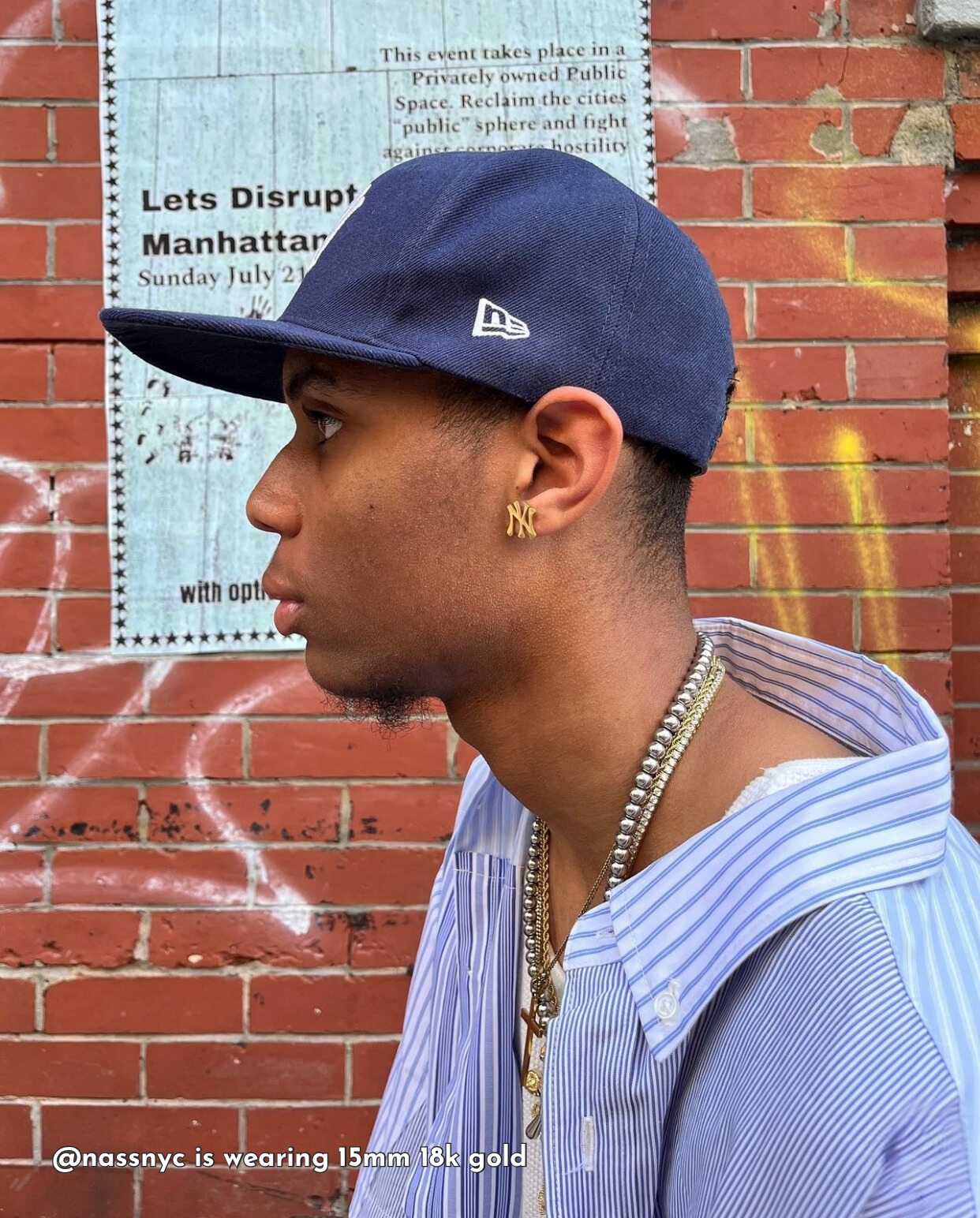 Male model wearing GRISÉ NYC gold New York NY logo stud earrings showing clean minimal unisex design and modern street style.