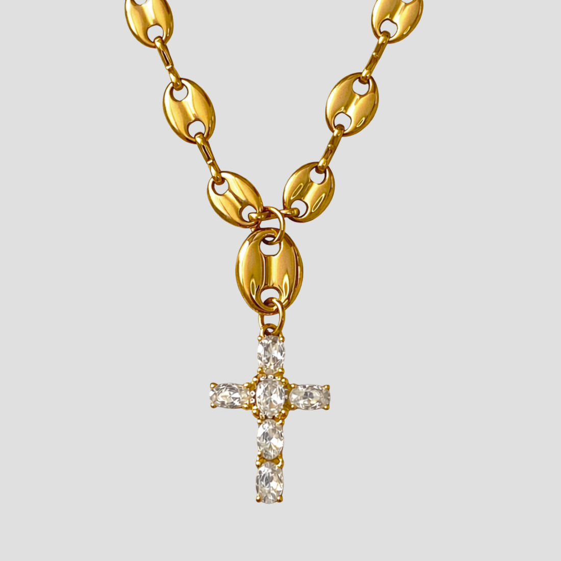 18k gold plated stainless steel mariner link cross pendant necklace with stone set cross on plain background.