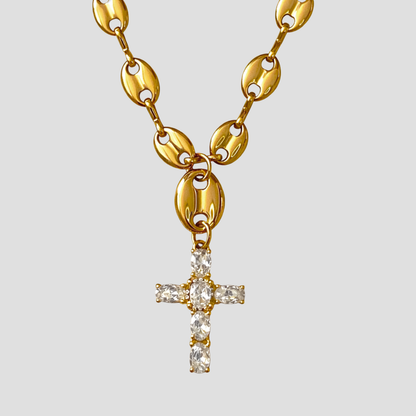 18k gold plated stainless steel mariner link cross pendant necklace with stone set cross on plain background.