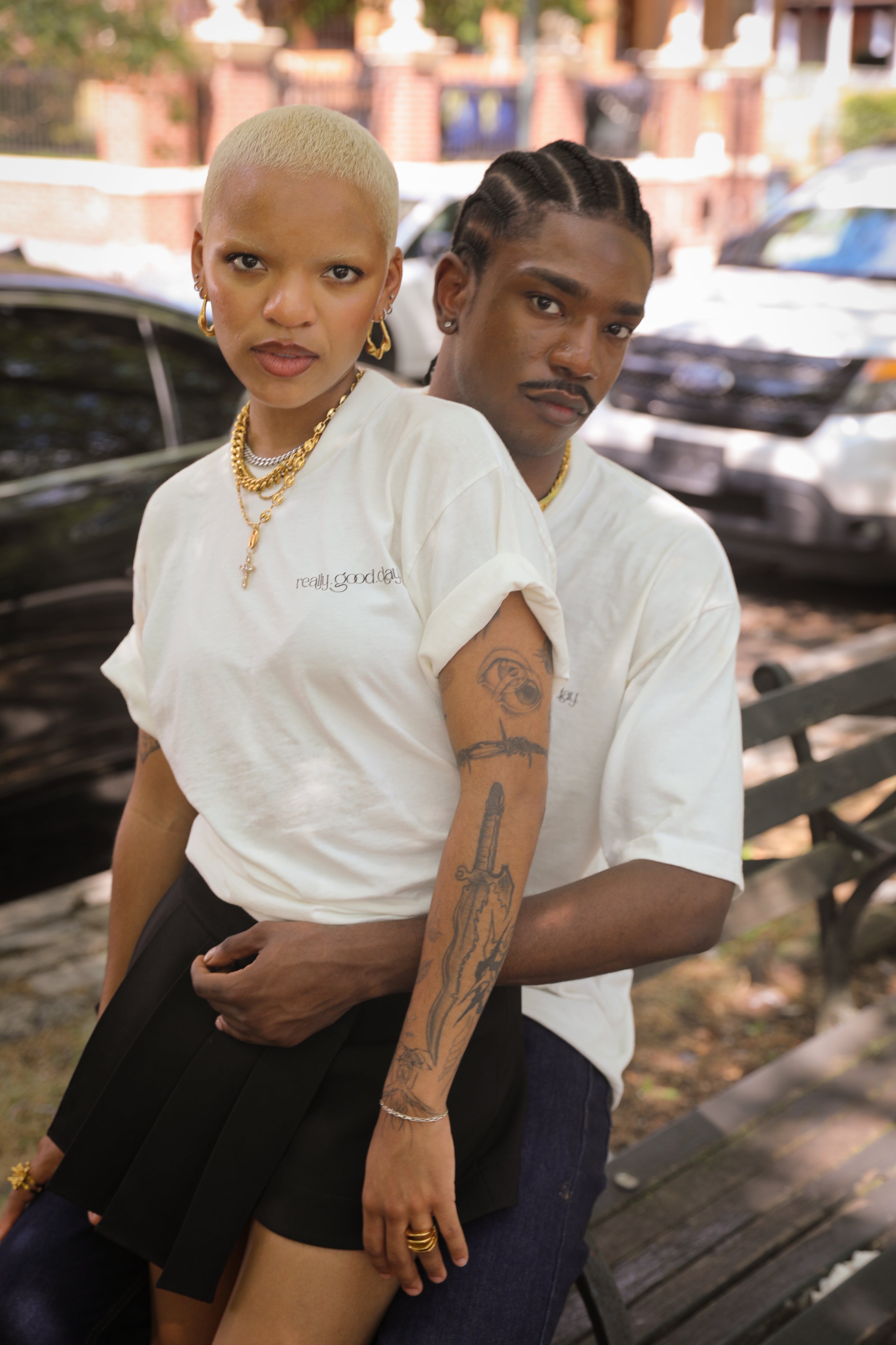 Unisex mariner link cross pendant necklace in gold stainless steel worn by models lifestyle photo.