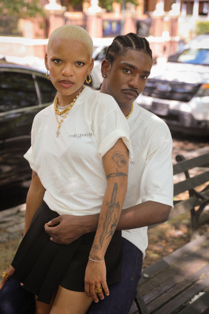 Unisex mariner link cross pendant necklace in gold stainless steel worn by models lifestyle photo.