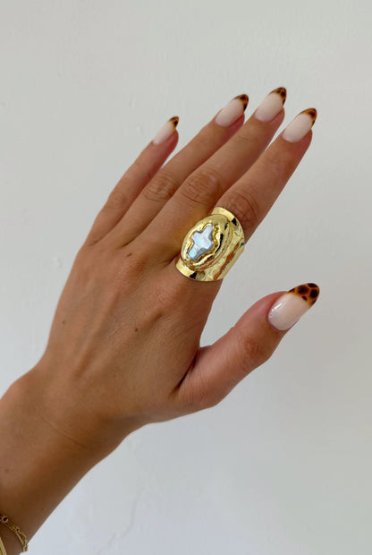 Model wearing Mother of Perlita Cross gold signet ring with mother of pearl cross by GRISÉ NYC.