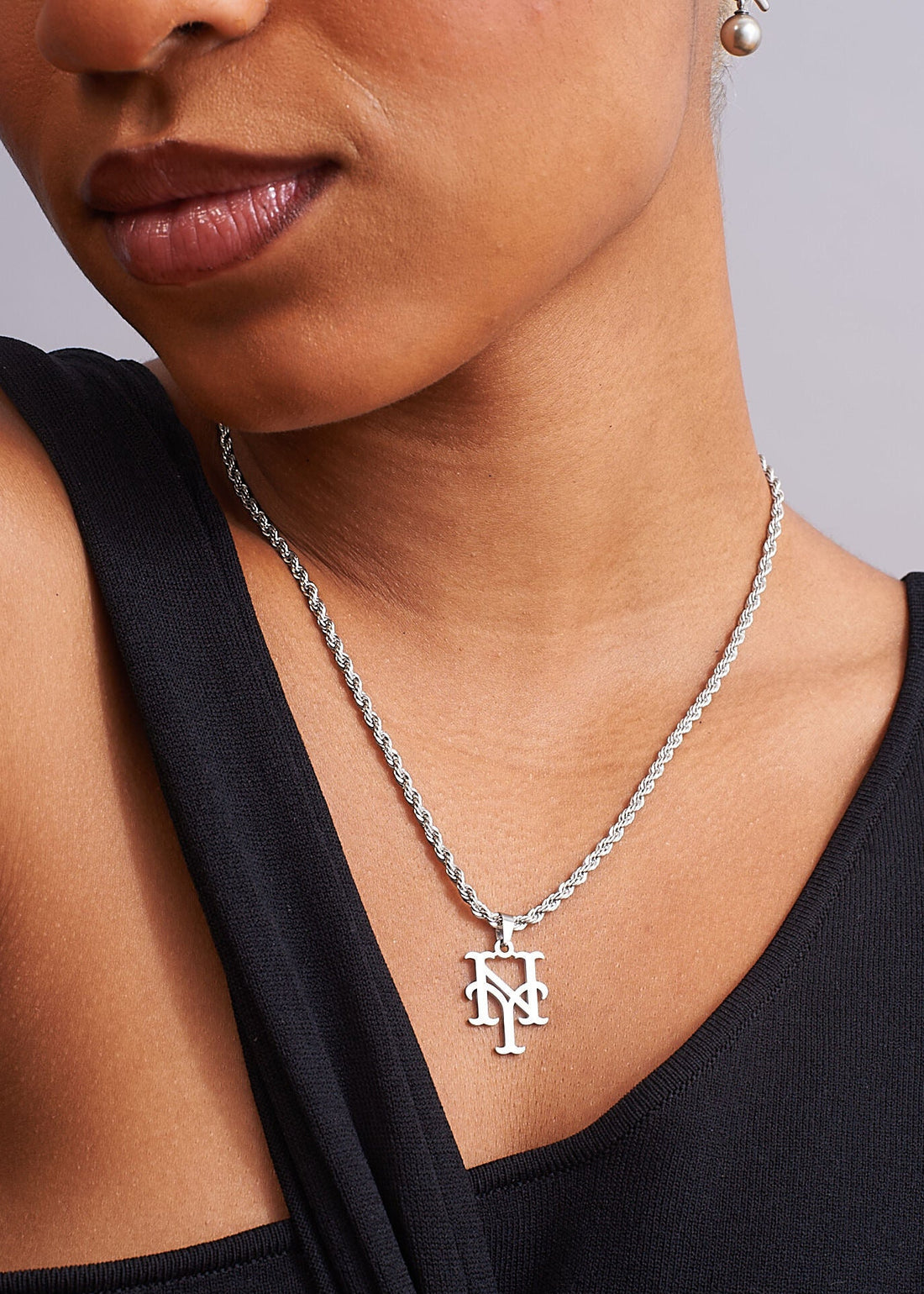 Front view of model wearing silver New York Mets stainless steel rope necklace, tarnish resistant unisex pendant by GRISÉ NYC.