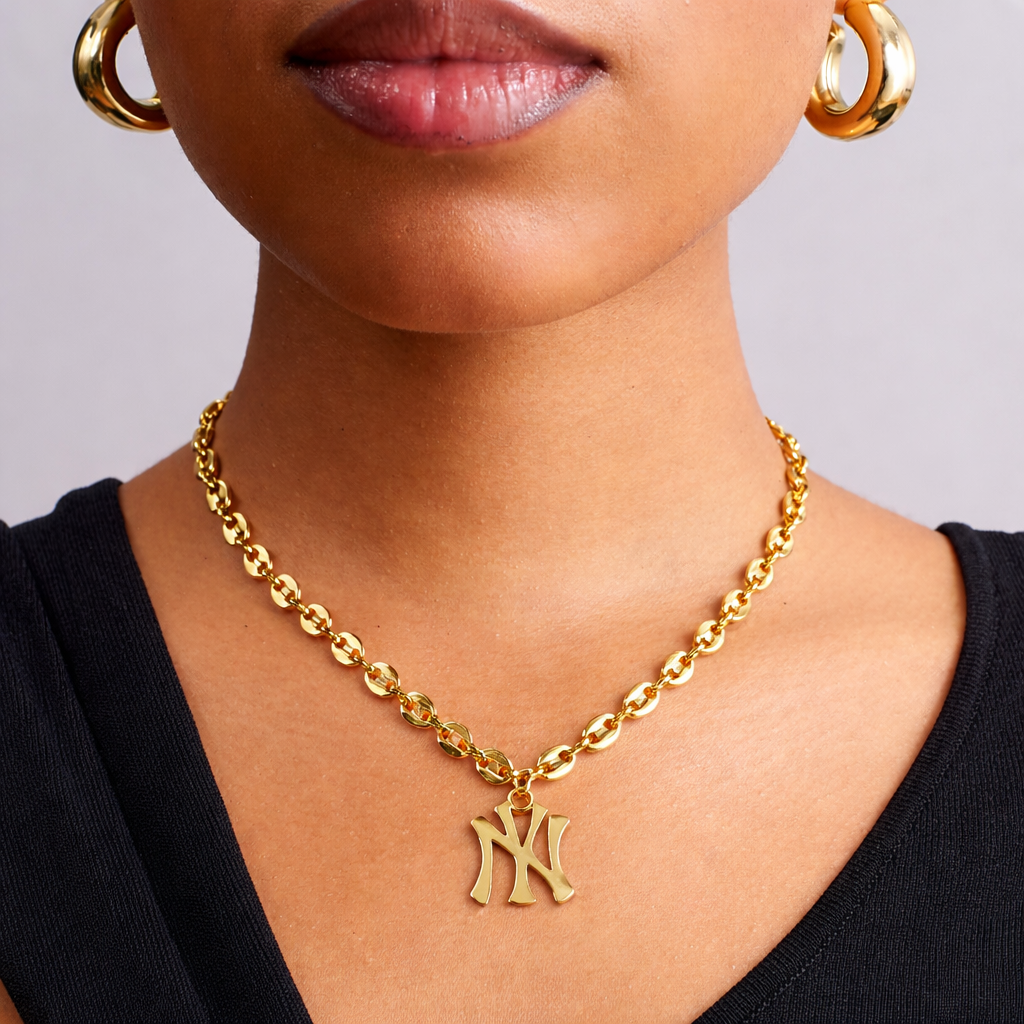 Model wearing New York Yankees 18k gold mariner necklace, tarnish resistant stainless steel jewelry by GRISÉ NYC.