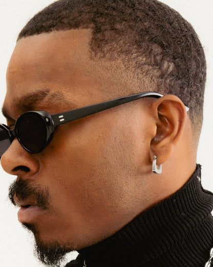 Mini Square Stainless Steel Earrings by GRISÉ NYC featuring secure hinged latch back closure in high polish silver worn on model.