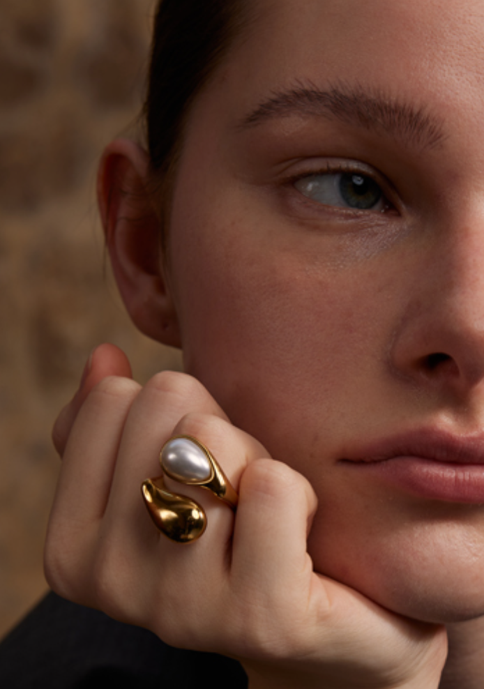 Model wearing the Perlita Eclipse 18k Gold Ring with pearl detail, elegant sculptural style by GRISÉ NYC.