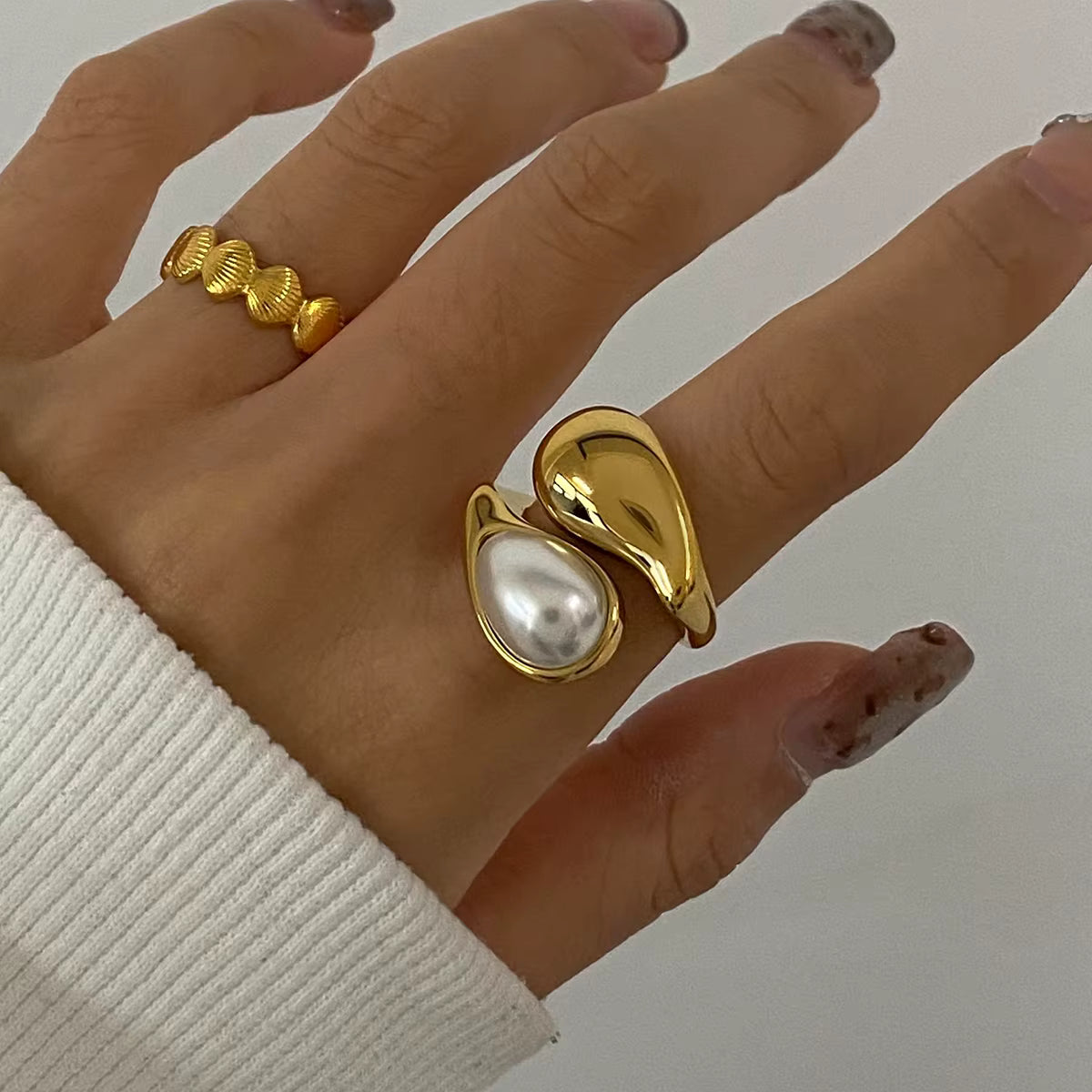 Model wearing Perlita Eclipse 18k Gold Ring by GRISÉ NYC with cozy neutral sweater style.