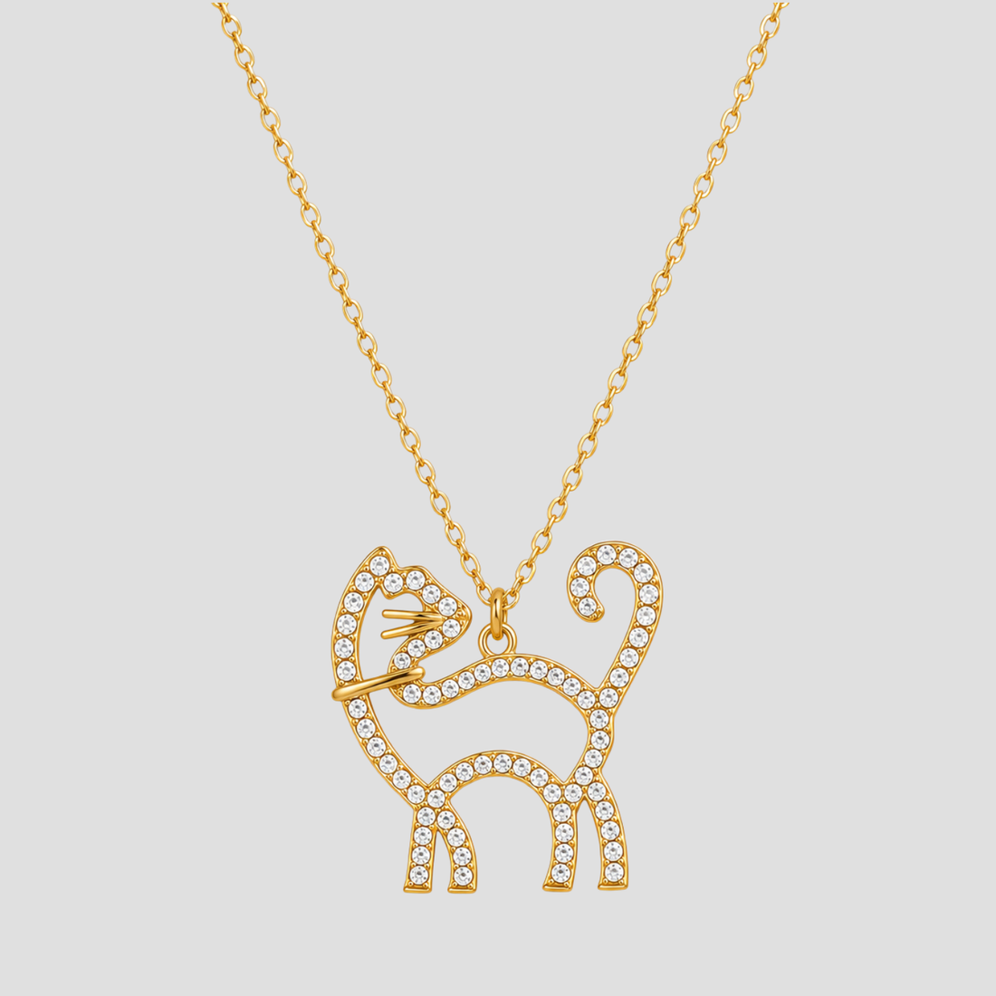 GRISÉ NYC 18k gold plated rhinestone kitty cat necklace with crystal detailing on a delicate gold chain against a light grey background