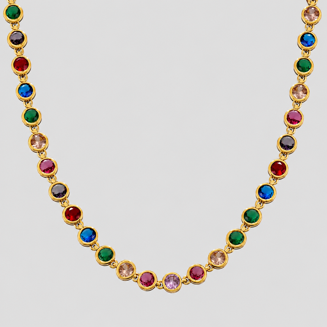 Royal Multicolor Gemstone Necklace 2.0 in 18k gold plated stainless steel with vibrant rainbow cubic zirconia stones on gray background.