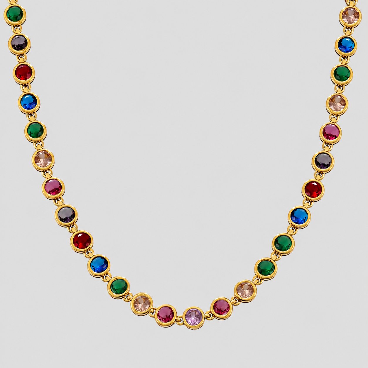 Royal Multicolor Gemstone Necklace 2.0 in 18k gold plated stainless steel with vibrant rainbow cubic zirconia stones on gray background.