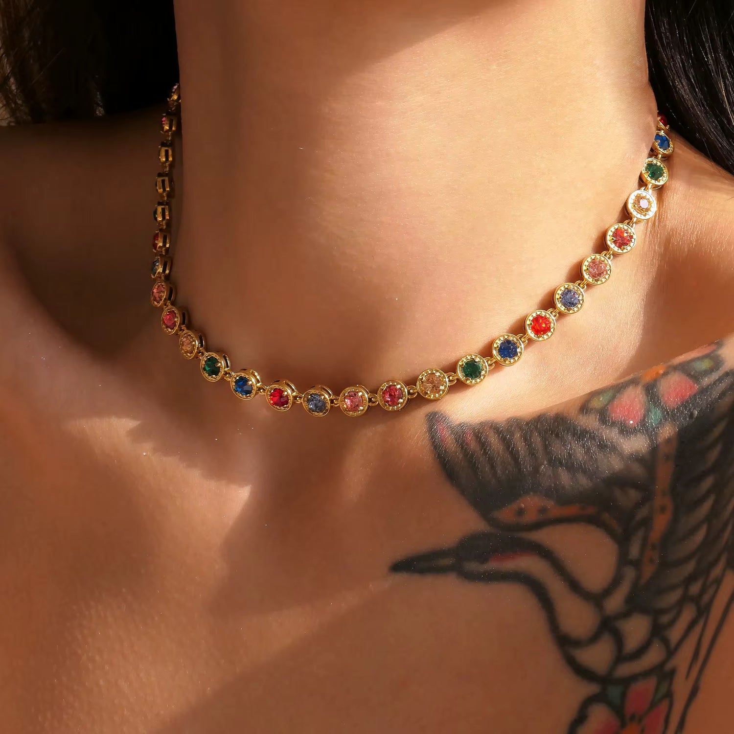 Side angle close up of Royal rainbow gemstone necklace styled on neck