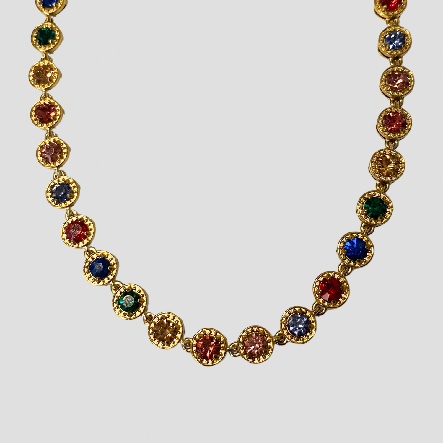 Royal 18k gold multicolor gemstone necklace with cubic zirconia stones on white background