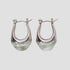 Sage resin oval stainless steel drop earrings by GRISÉ NYC with sculptural teardrop silhouette and silver hardware.