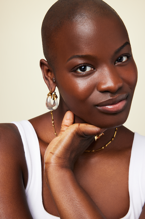 Gold resin hoop earrings on model lightweight statement hoops by GRISÉ NYC 