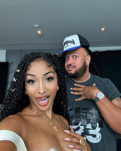 Close up lifestyle photo of gold stainless steel mariner link cross pendant necklace worn by music artist Shenseea.