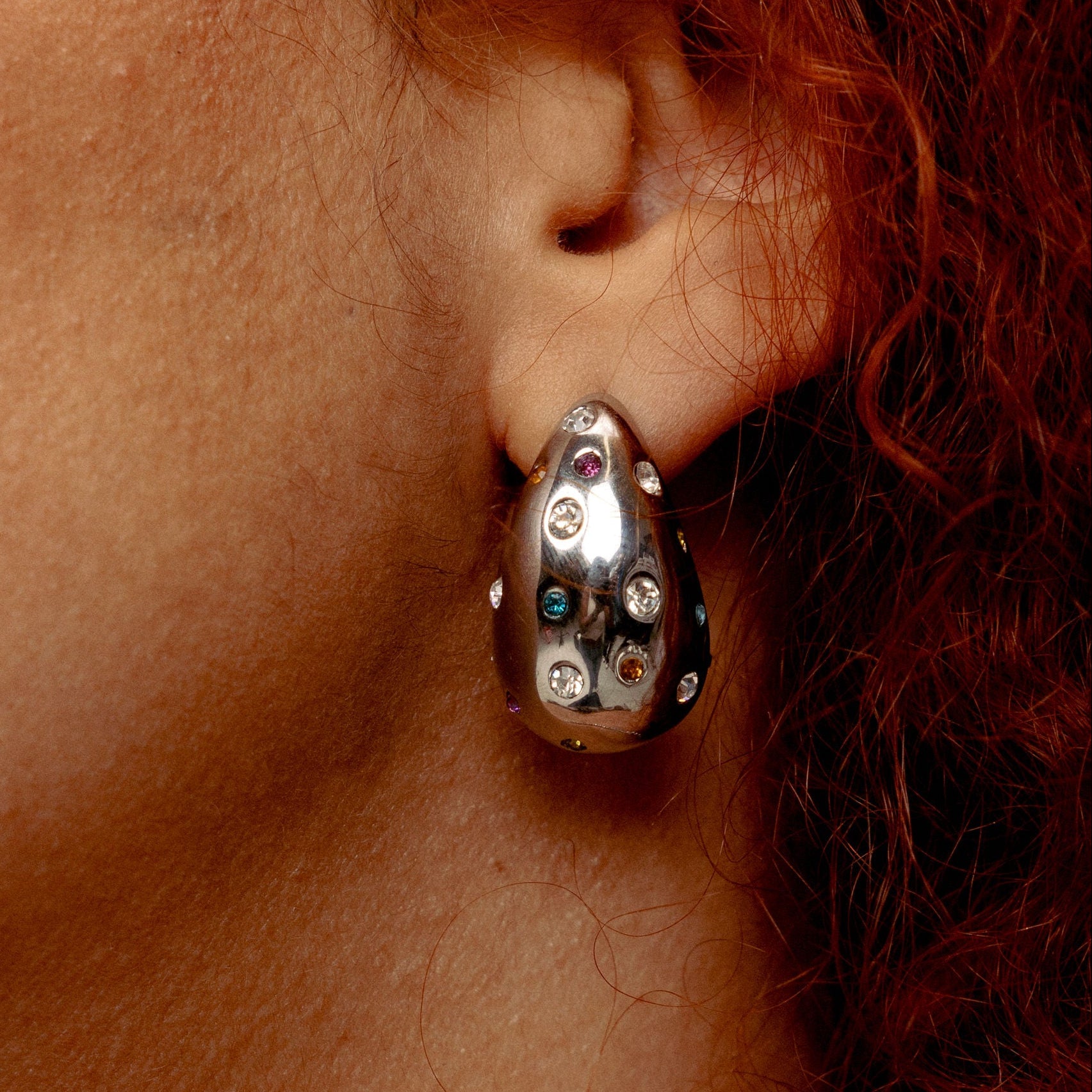 Silver rainbow pavé teardrop earrings by GRISÉ NYC with multicolor cubic zirconia and sculptural stainless steel drop design.