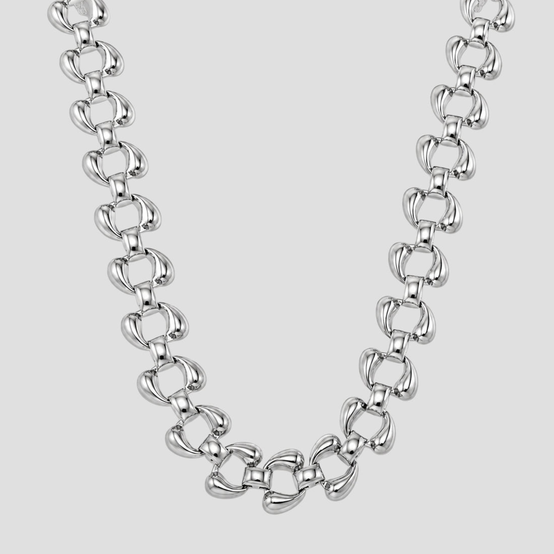A polished silver-tone Sovereign chain necklace with elongated, rounded links, displayed against a solid light gray background.