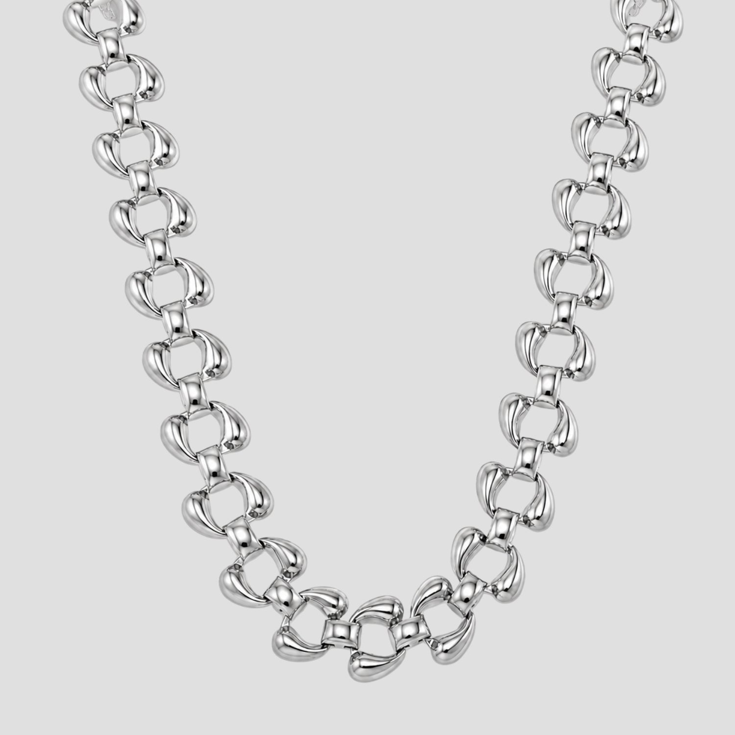 A polished silver-tone Sovereign chain necklace with elongated, rounded links, displayed against a solid light gray background.