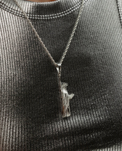 Close up Statue of Liberty silver pendant necklace styling photo by GRISÉ NYC