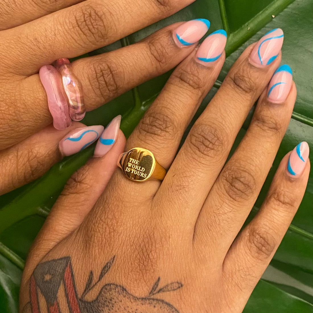 The World Is Yours 18k gold plated signet ring worn on hand by GRISÉ NYC