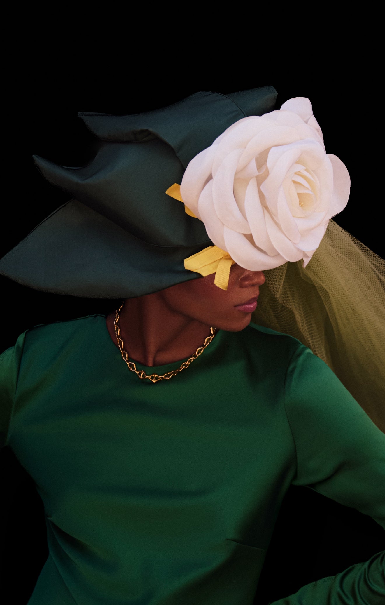 Female model wearing triangle mariner gold stainless steel necklace by GRISÉ NYC.