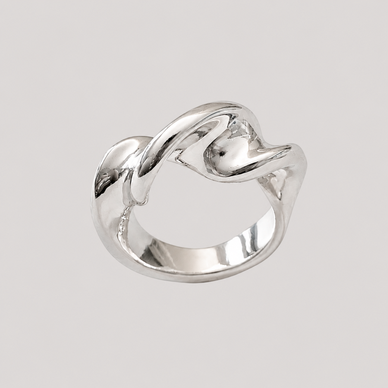 Twist Silver Ring by GRISÉ NYC featuring a sculptural twisted silver plated design on a light grey background 
