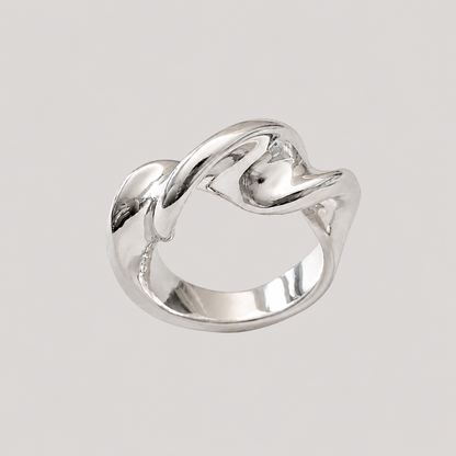 Twist Silver Ring by GRISÉ NYC featuring a sculptural twisted silver plated design on a light grey background 