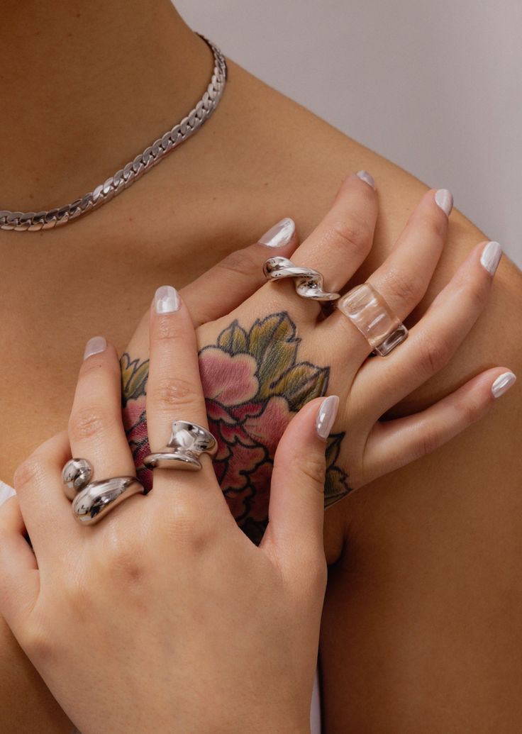 Twist Silver Ring by GRISÉ NYC styled with layered silver rings for an edgy stacked jewelry look