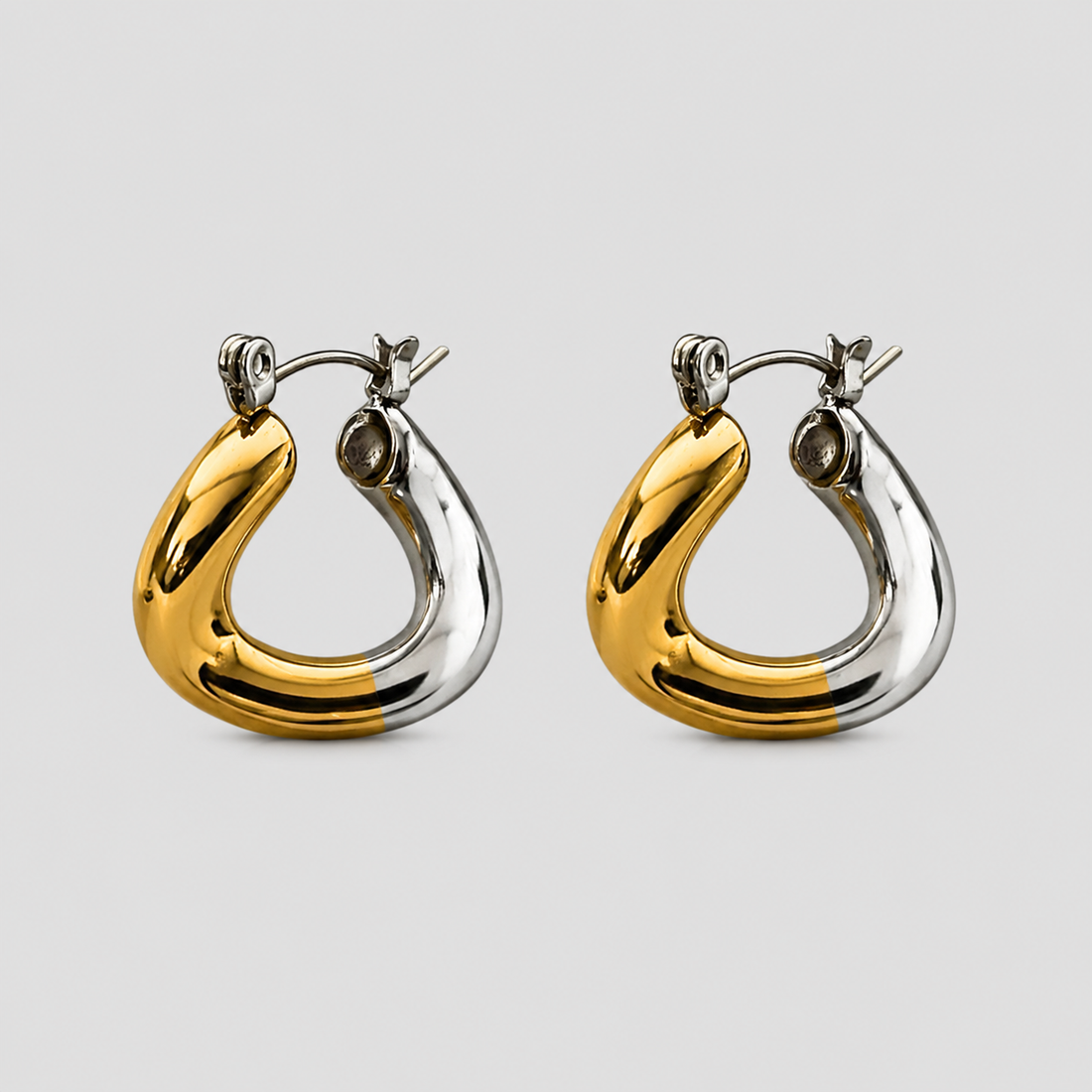Pair of two-tone trapezoid twist hoop earrings featuring polished 18K gold-plated and stainless steel finishes by GRISÉ NYC.