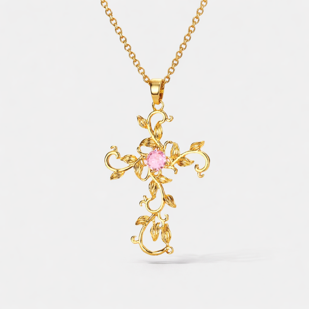 Valentina Cross necklace in 18K gold plated stainless steel featuring pink gemstone center and intricate vine detailing.