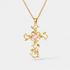 Valentina Cross necklace in 18K gold plated stainless steel featuring pink gemstone center and intricate vine detailing.