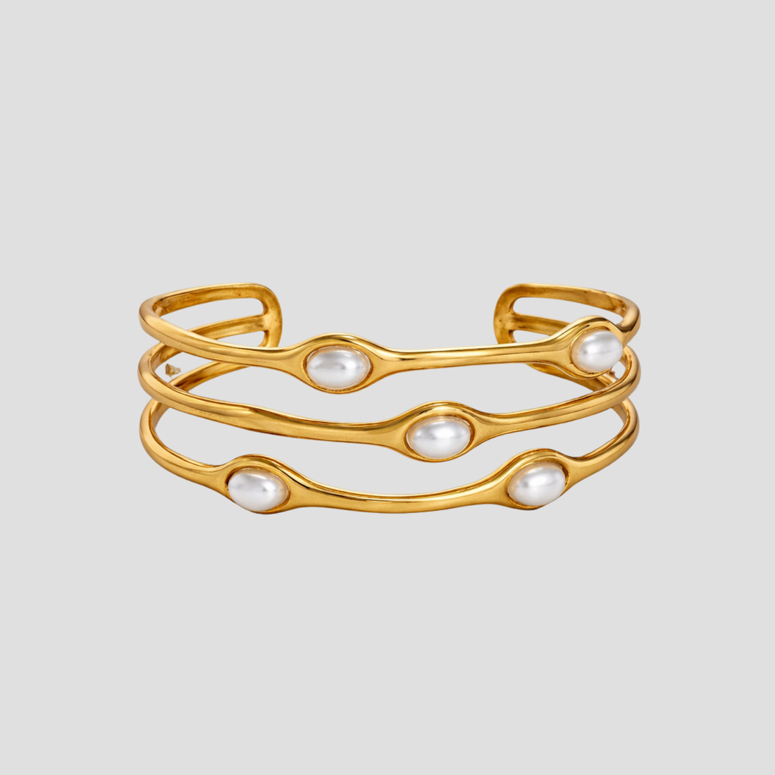 Wavy Perlita 18k gold cuff bracelet with pearl accents by GRISÉ NYC.