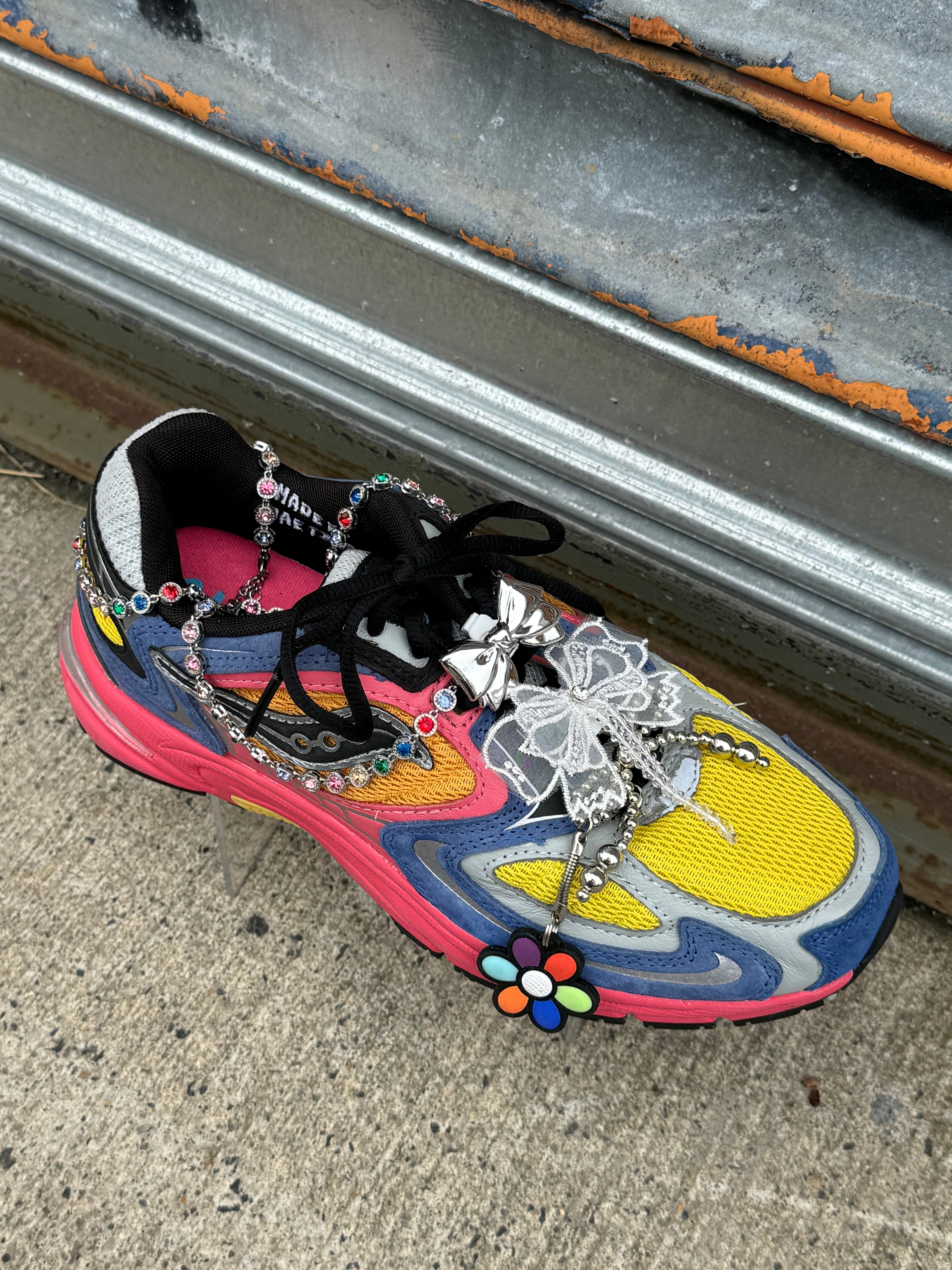 White and Black lace bow shoe charms clipped onto sneakers GRISÉ NYC.